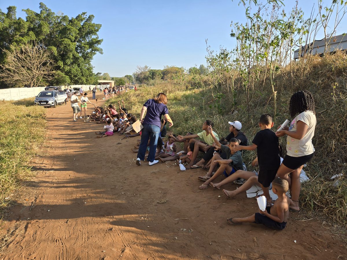 Volunteers handing food packages to children during the evening distribution